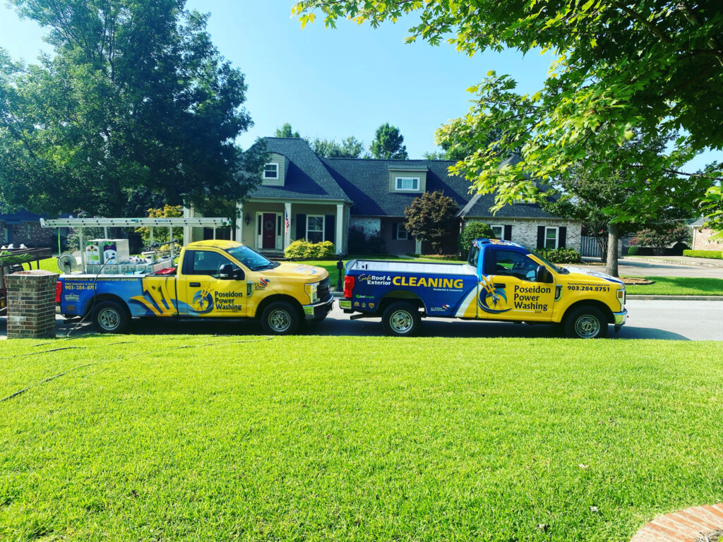 Poseidon Power Washing trucks parked outside a home, ready to clean the exterior surfaces